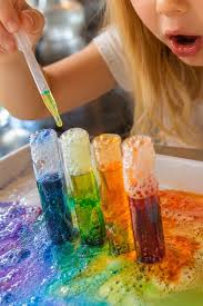 Child conducting a colorful science experiment